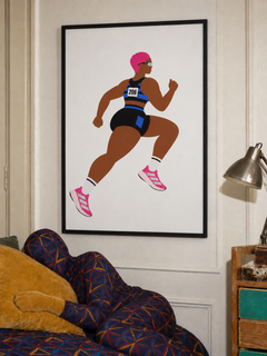 Pink Runner framed print above a patterned daybed with a camouflaged reclining figure.