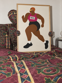 Oak-framed Run Auntie D Run held by a figure in a matching Amalfi Burgundy morphsuit on a patterned bed